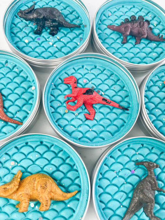 Light Blue Sensory Dough with Dinosaur Scales and a Dinosaur Rubber Toy in a Tin for Dinosaur themed party gifts