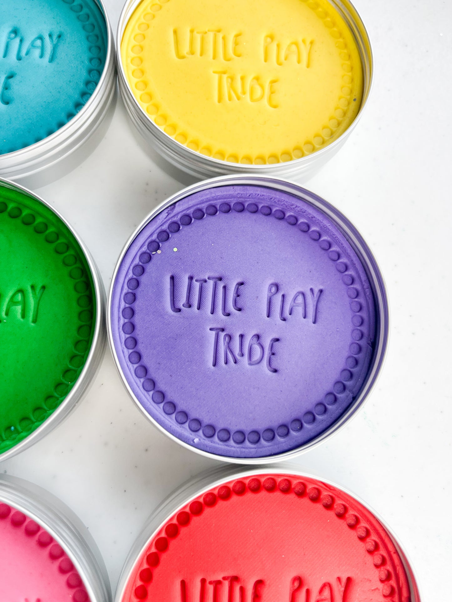 7 pots of coloured playdough in 250g maxi tubs for sensory play. Screen Free eco friendly sensory dough with scented coloured playdough. Purple playdough with Little Play Tribe imprint