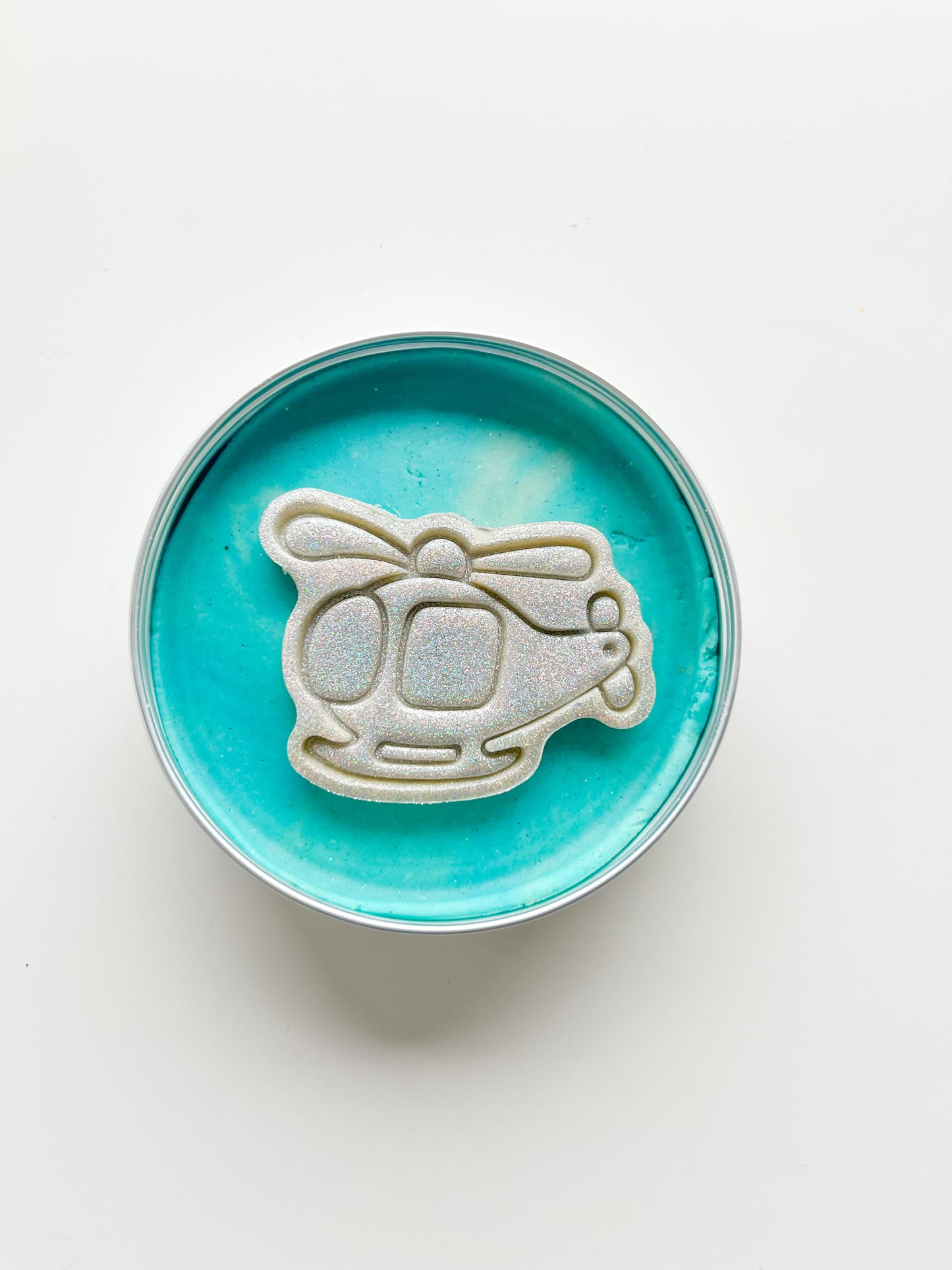 Tins of Blue Playdough with glitter transport themed topper for themed alternative eco friendly party bag fillers. Helicopter dough