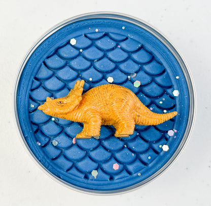 Dark Blue Sensory Playdough with dinosaur scales and rubber dinosaur toy in the tin for party bag fillers