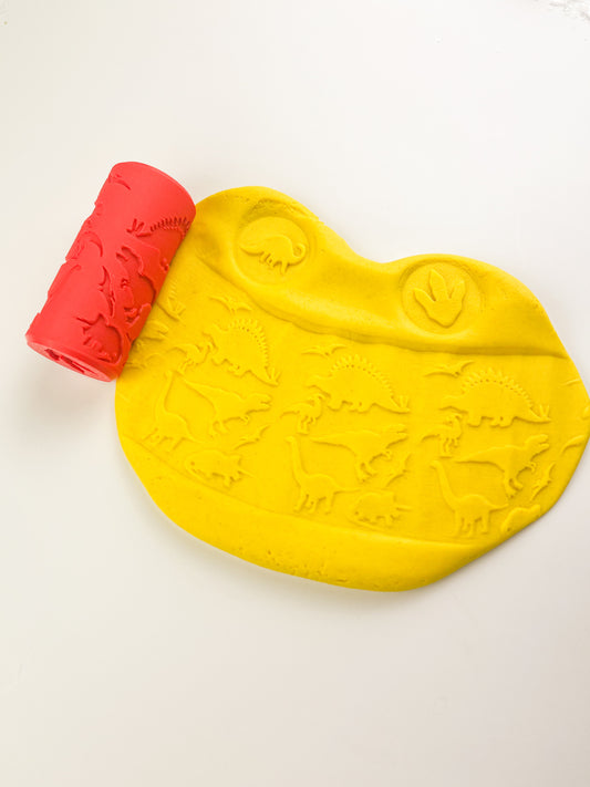 Red Dinosaur Eco Playdough roller with yellow sensory dough. Play tools and accessory zoomed out