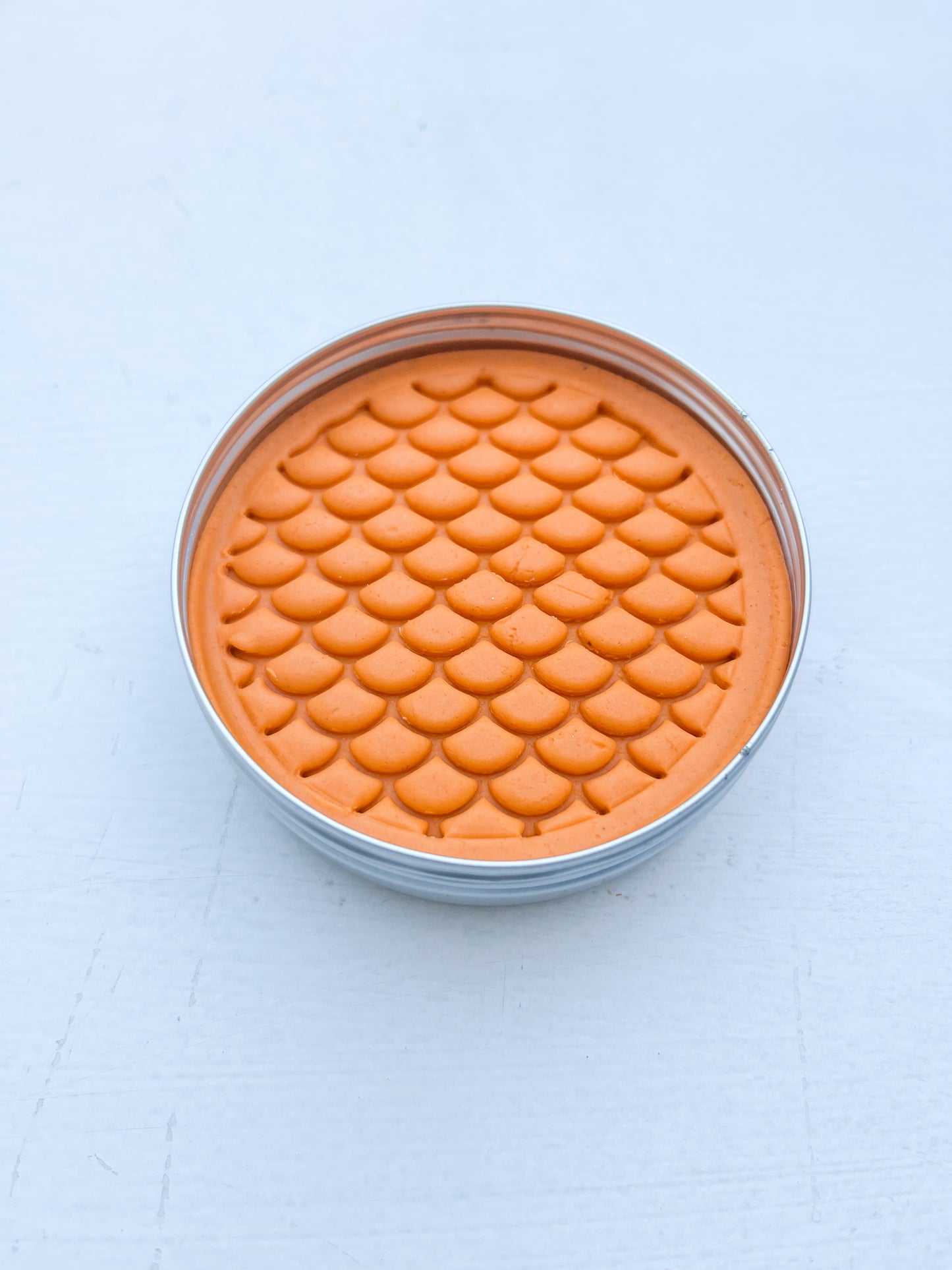 Tin of orange playdough for eco friendly party bag fillers printed with dinosaur scales