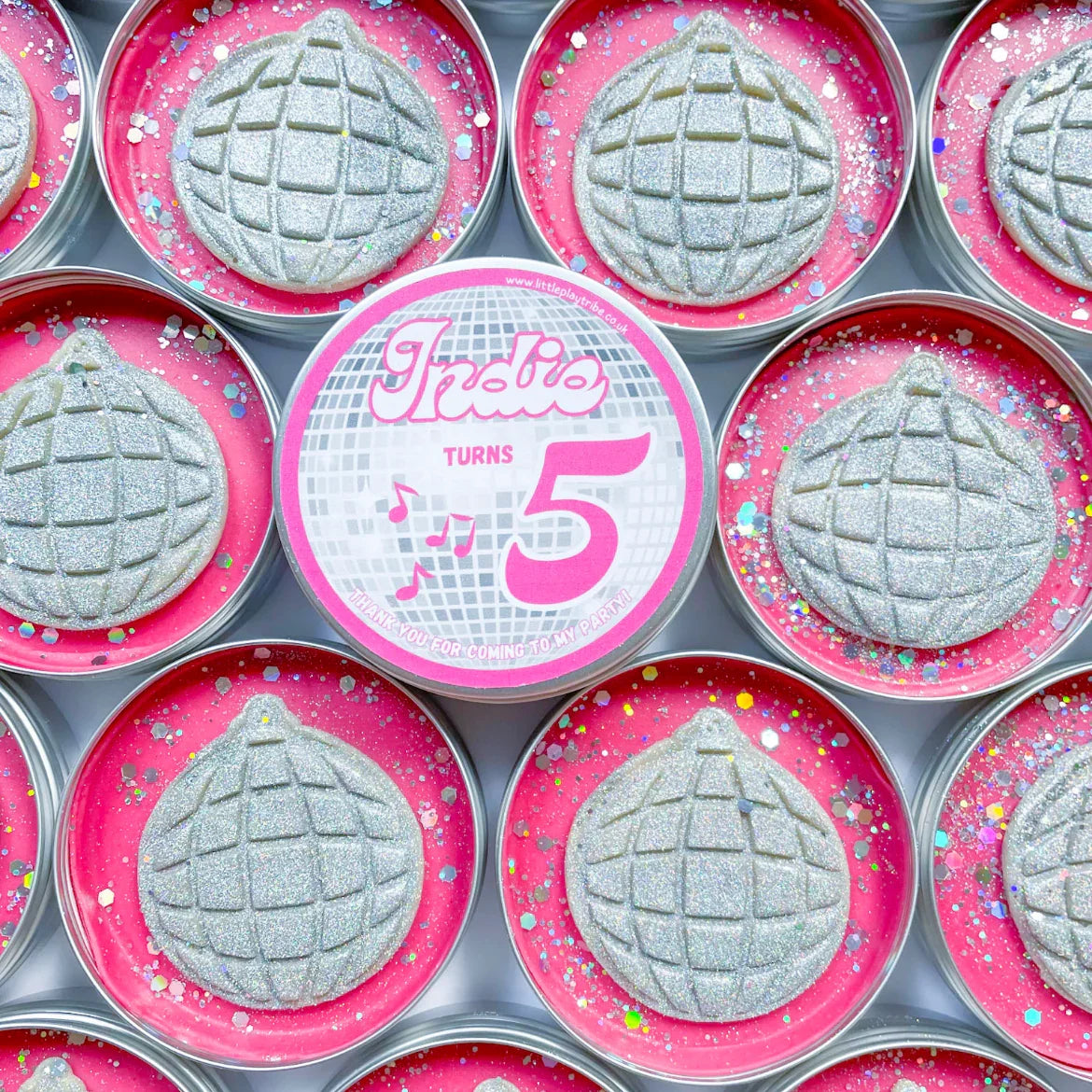 Disco ball theme party pots. Tins with pink playdough topped with silver glitter disco ball cutout dough for disco themed party bag fillers. Personalised Indie turns 5 label in the middle