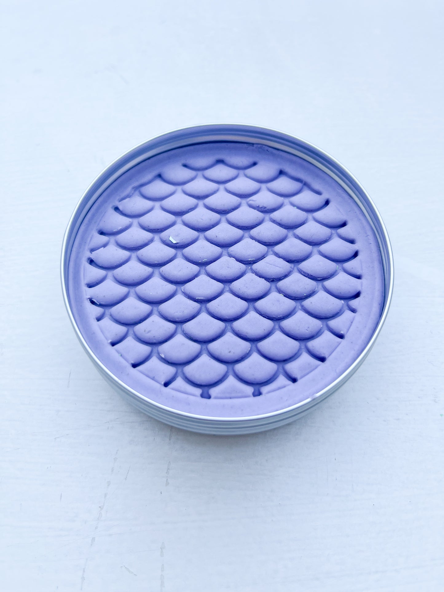 Tin of purple playdough for eco friendly party bag fillers printed with dinosaur scales