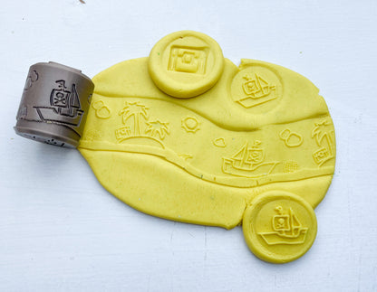 plastic free eco roller with pirate themed imprints showing pirate shapes on yellow playdough with this tool