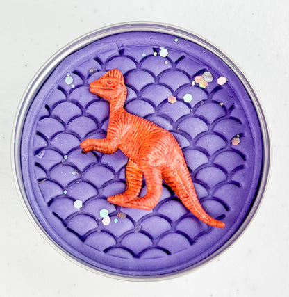 Plum Purple playdough tin with a red dinosaur figure on a white background