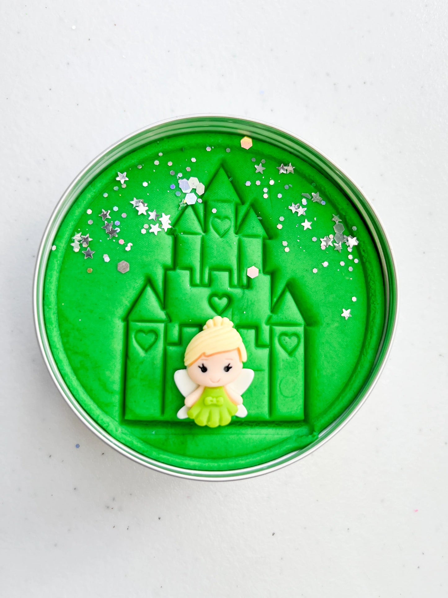 Tin of green playdough imprinted with castle and princess figure for princess themed kids birthday party favours. Eco friendly and plastic free alternative party bag fillers