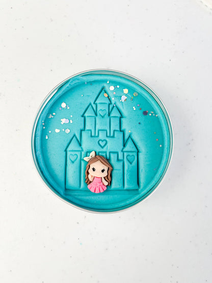 Tin of blue playdough imprinted with castle and princess figure for princess themed kids birthday party favours. Eco friendly and plastic free alternative party bag fillers