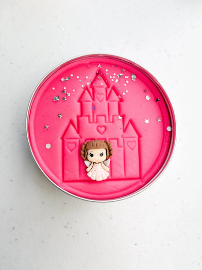 Tin of pink playdough imprinted with castle and princess figure for princess themed kids birthday party favours. Eco friendly and plastic free alternative party bag fillers