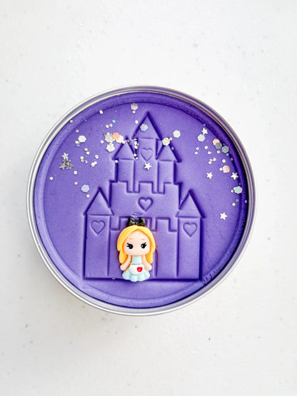 Tin of purple playdough imprinted with castle and princess figure for princess themed kids birthday party favours. Eco friendly and plastic free alternative party bag fillers
