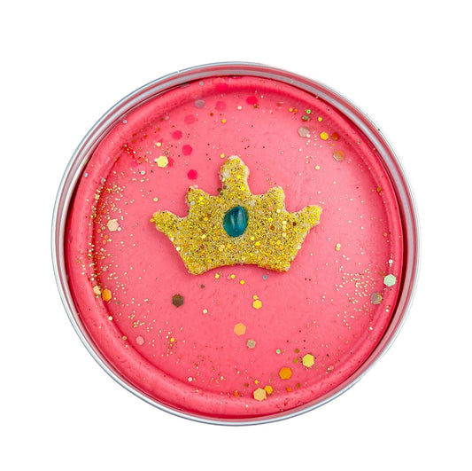 Tin filled with pink sensory playdough with hidden princess figures with gold glitter crown on top