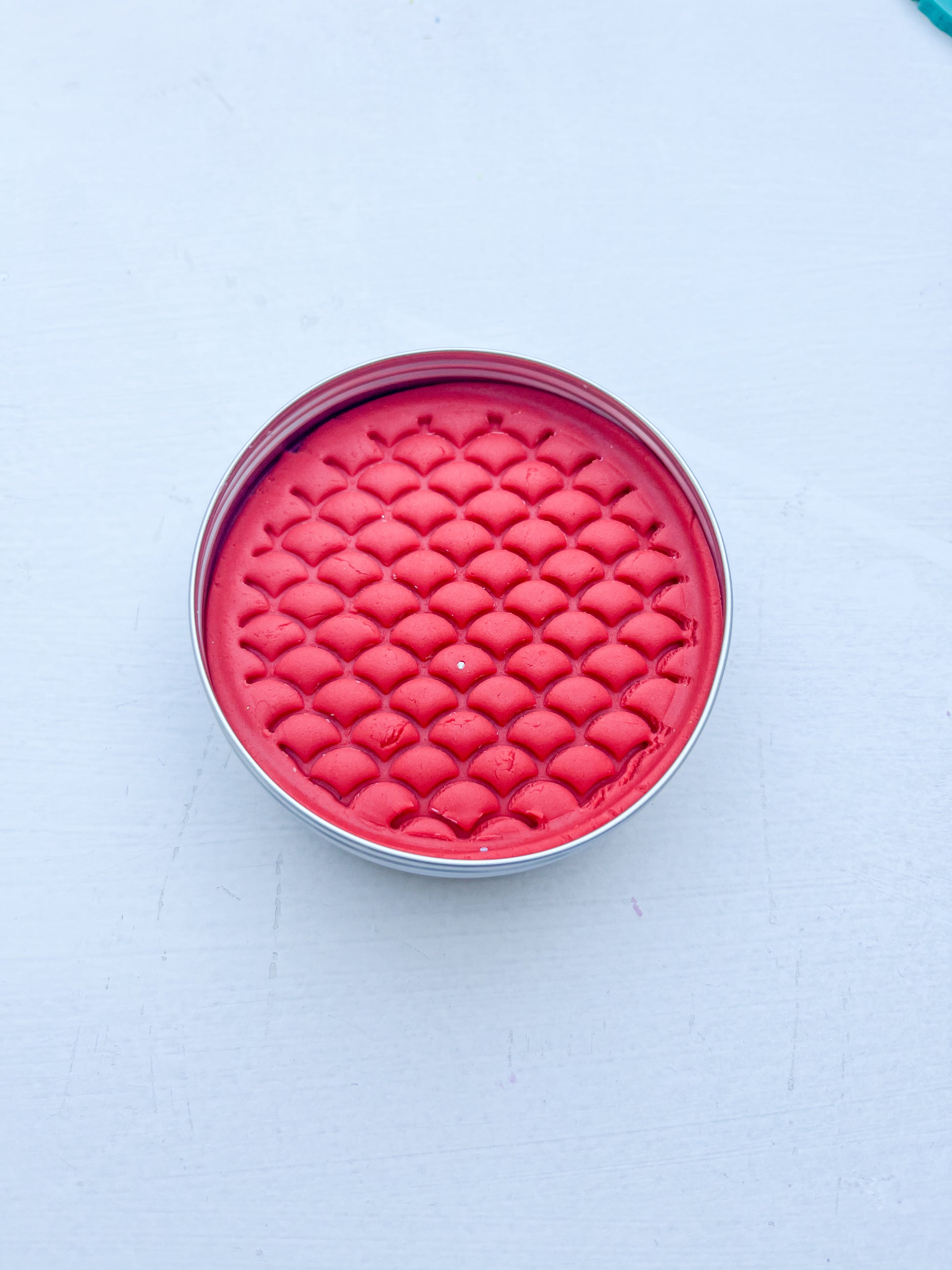 Tin of red playdough for alternative eco party bag fillers printed with dinosaur scales