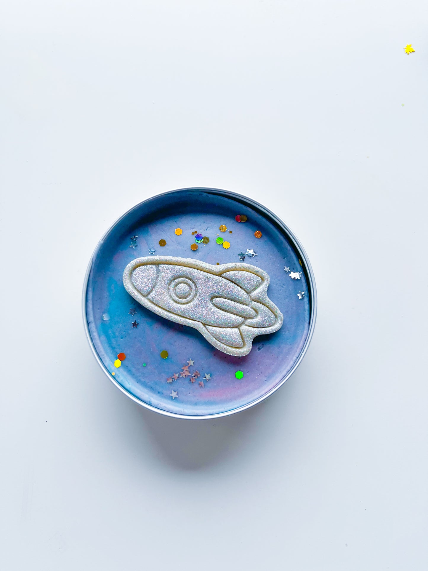 Tin filled with galactic space dough and glitter rocket for kids space and rocket themed alternative party bag fillers. Eco friendly playdough gifts