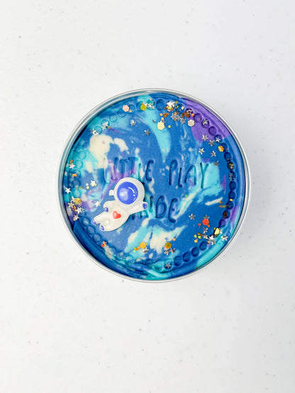 Space themed tin of sensory scented galaxy playdough for alternative eco friendly party bag fillers for space themed kids birthday parties with astronaught space charm