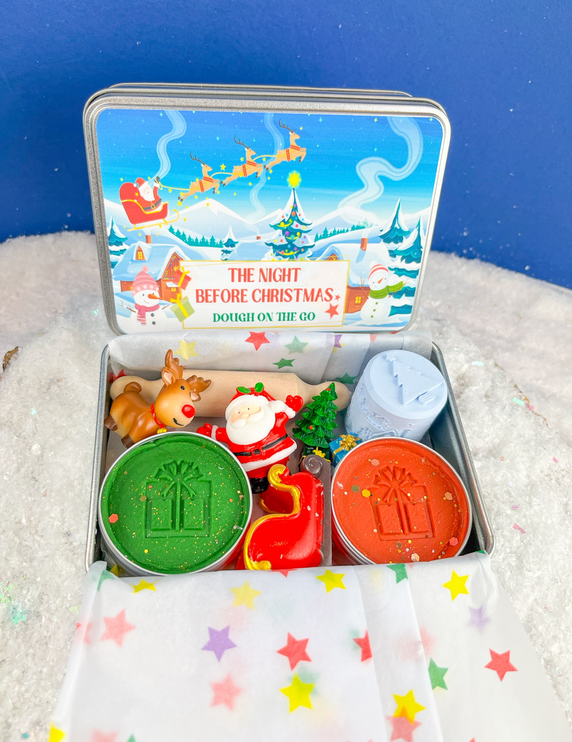 Set of Christmas-themed play dough and accessories in a tin with Christmas scenes ready for imaginative play