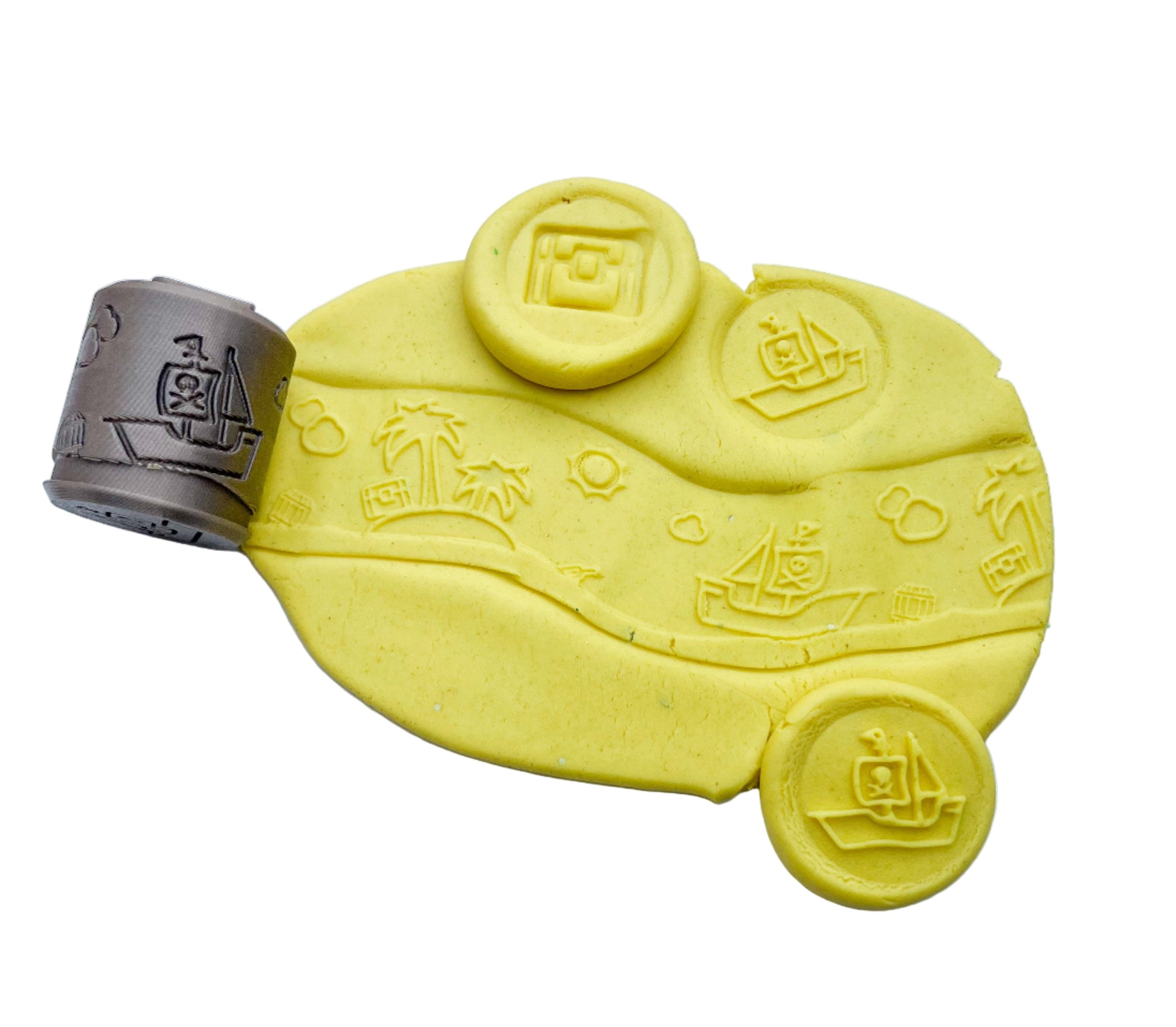 plastic free eco roller with pirate themed imprints showing pirate shapes on yellow playdough with this tool