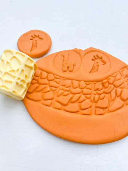 plastic free eco roller with safari themed imprints showing animal themed shapes on orange playdough with this tool