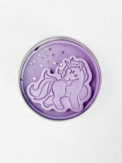 Tin filled with purple Playdough with a unicorn shape dough topper and glitter 