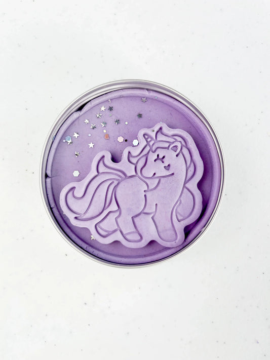 Tin filled with purple Playdough with a unicorn shape dough topper and glitter 